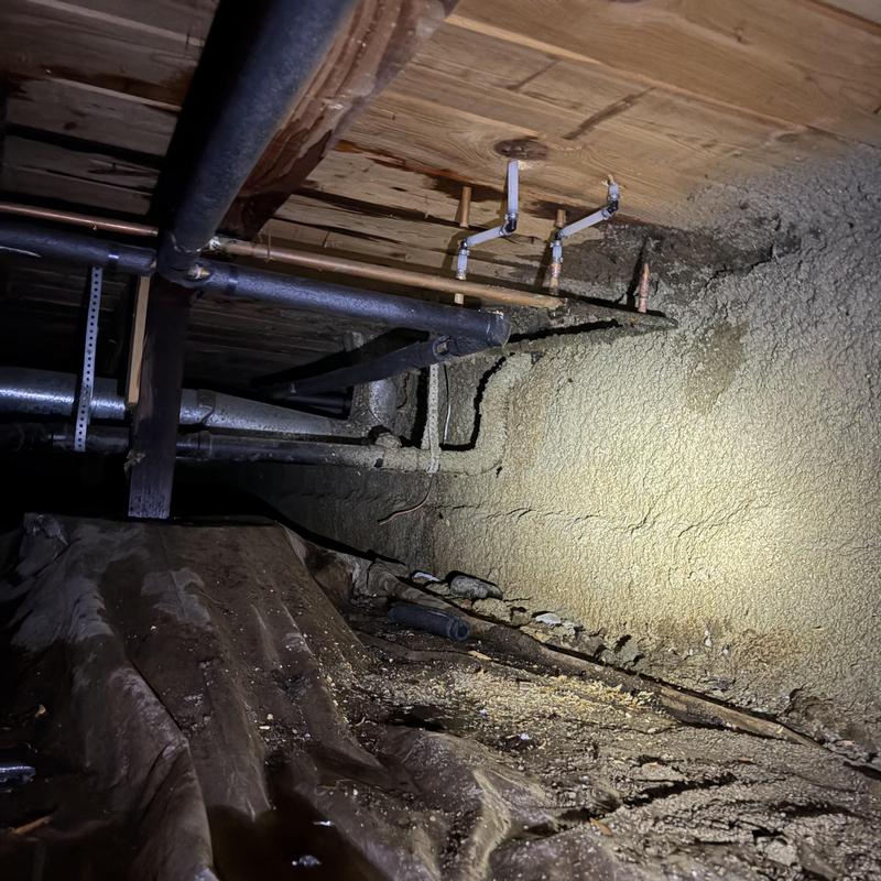 Copper plumbing pipes with pinhole leaks in crawlspace