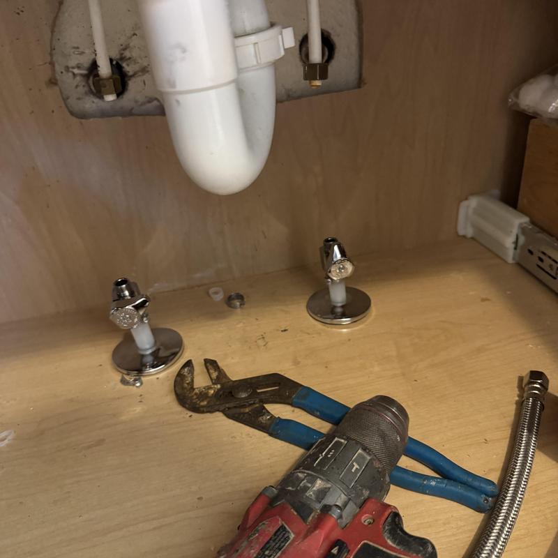 Bathroom sink angle stops with tools underneath