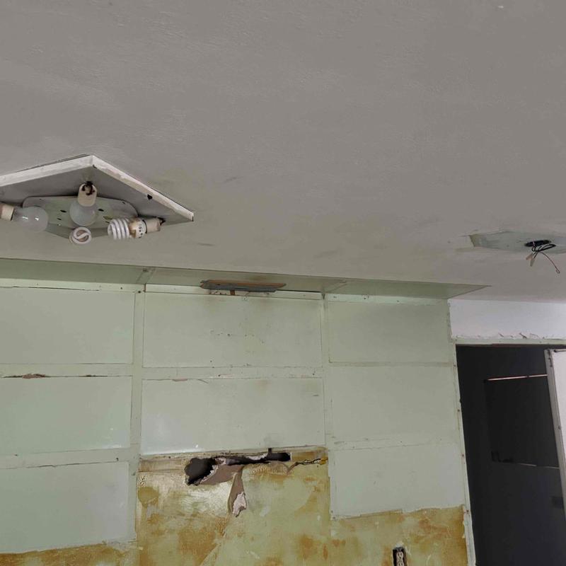 Ceiling light fixture with exposed wiring and wall damage Ceiling light fixture with exposed wiring and wall damage