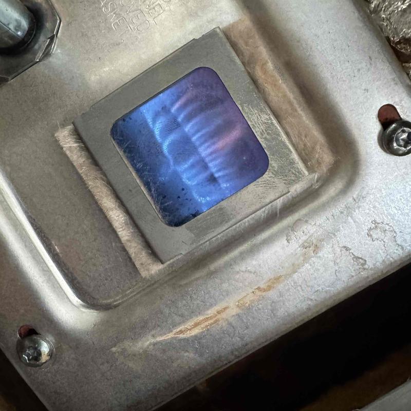 Gas water heater pilot flame through inspection window Gas water heater pilot flame through inspection window