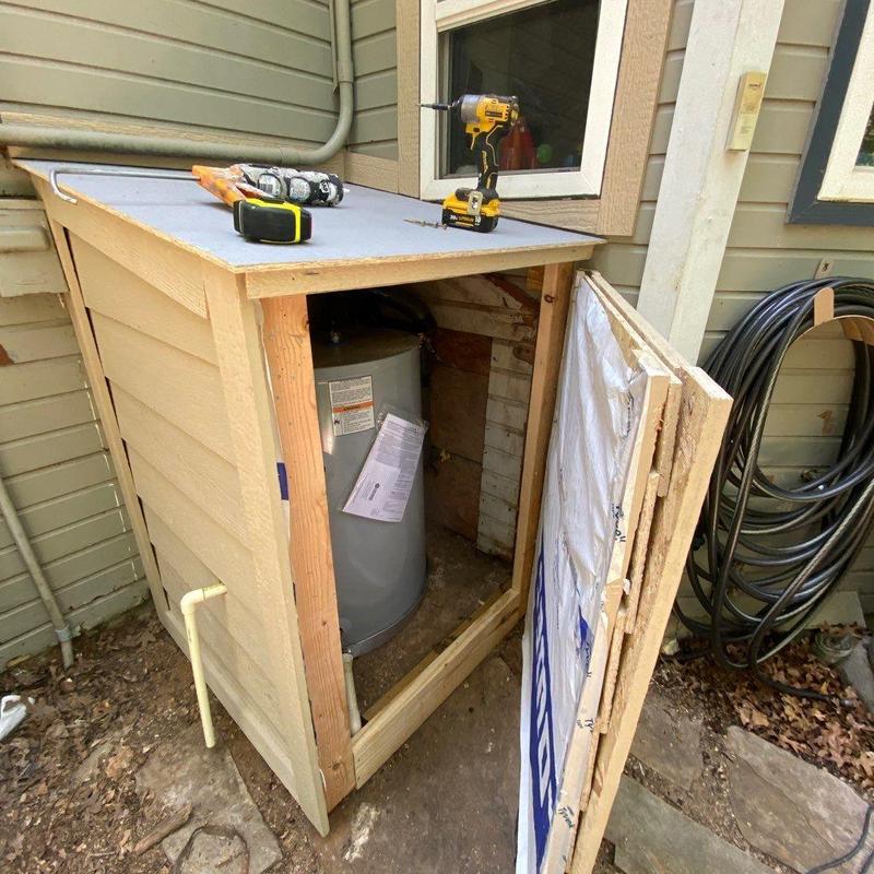 Exterior water heater shed with access panel Exterior water heater shed with access panel