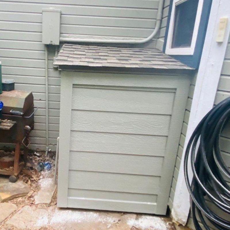 Exterior water heater shed with shingled roof Exterior water heater shed with shingled roof