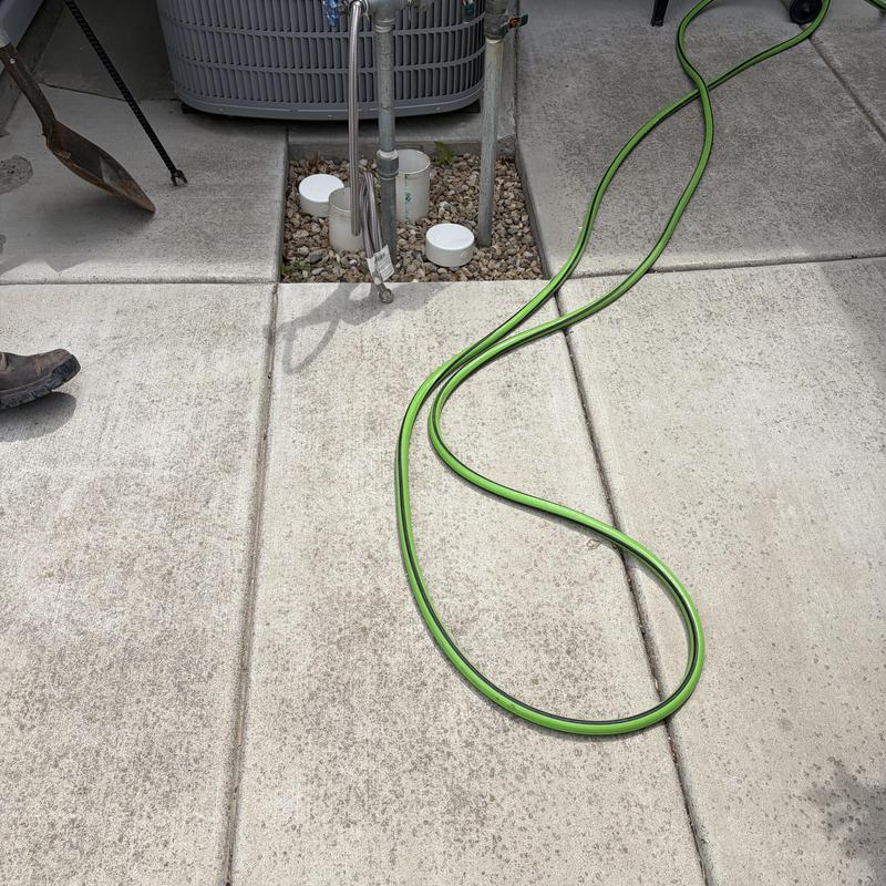 Curb stop valve access with irrigation hose and air conditioner Curb stop valve access with irrigation hose and air conditioner
