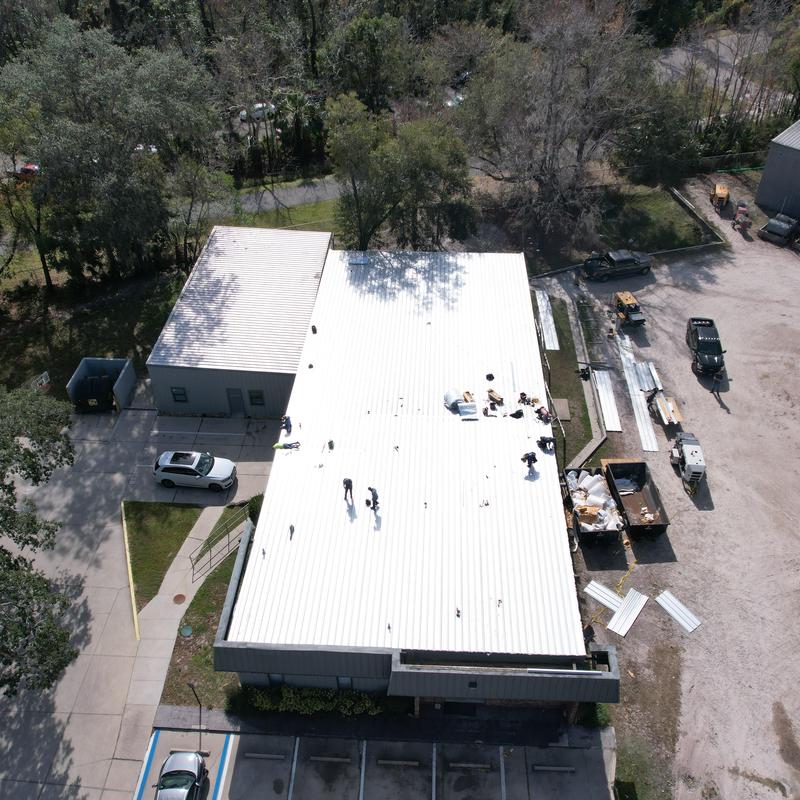 Metal roof panels installation over commercial building Metal roof panels installation over commercial building