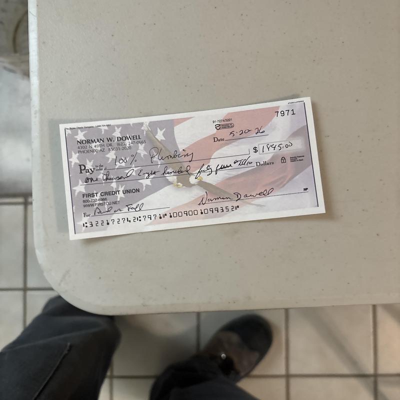 Plumbing service payment check on table in Glendale AZ