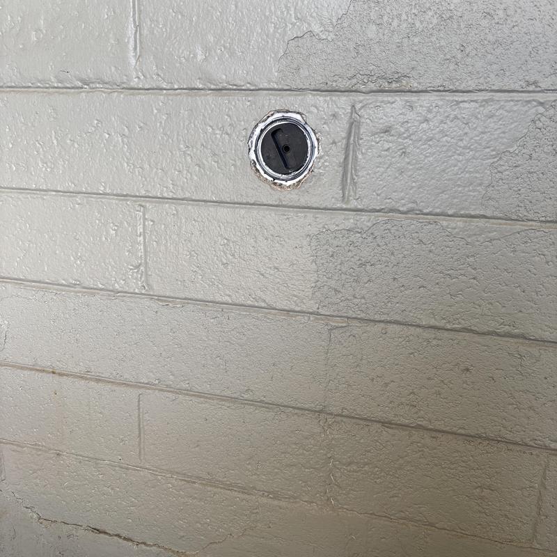 Gas meter inlet valve on exterior block wall