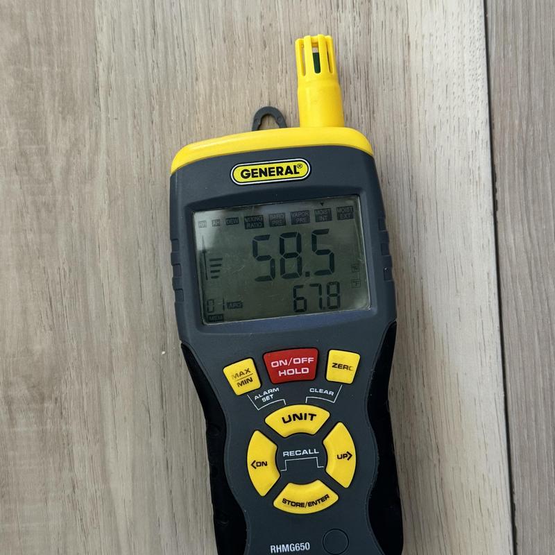 Moisture meter reading on LVP flooring surface