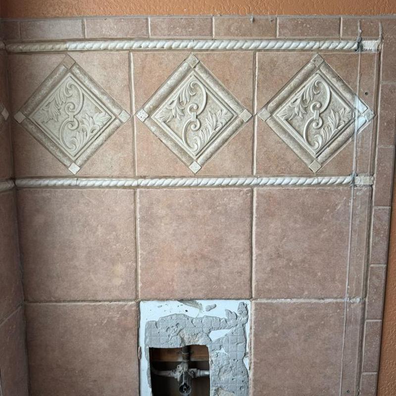 Shower valve wall tile cutout with old valve exposed Shower valve wall tile cutout with old valve exposed