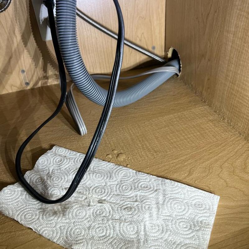 Garbage disposal area with leaks under sink cabinet Garbage disposal area with leaks under sink cabinet