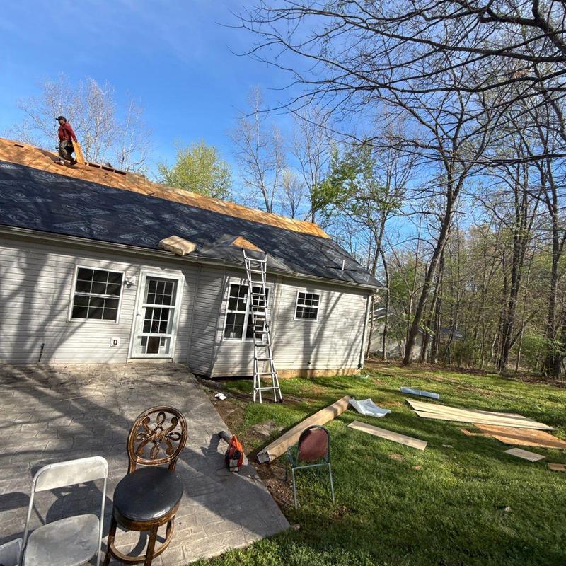 Three-tab shingle roof underlayment installation in progress
