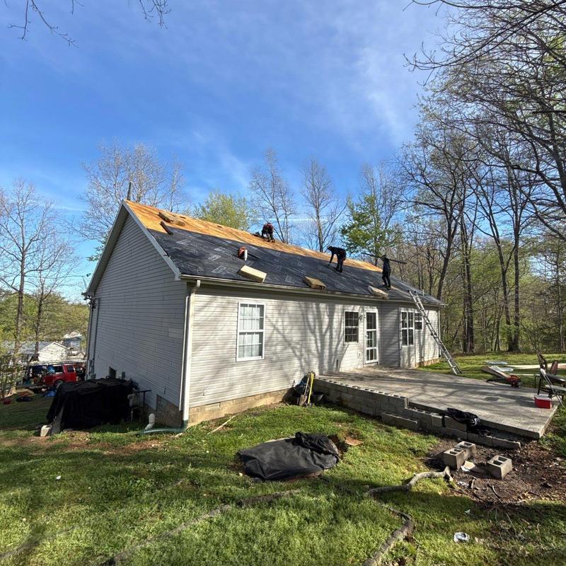 Three-tab shingle roof underlayment installation in progress