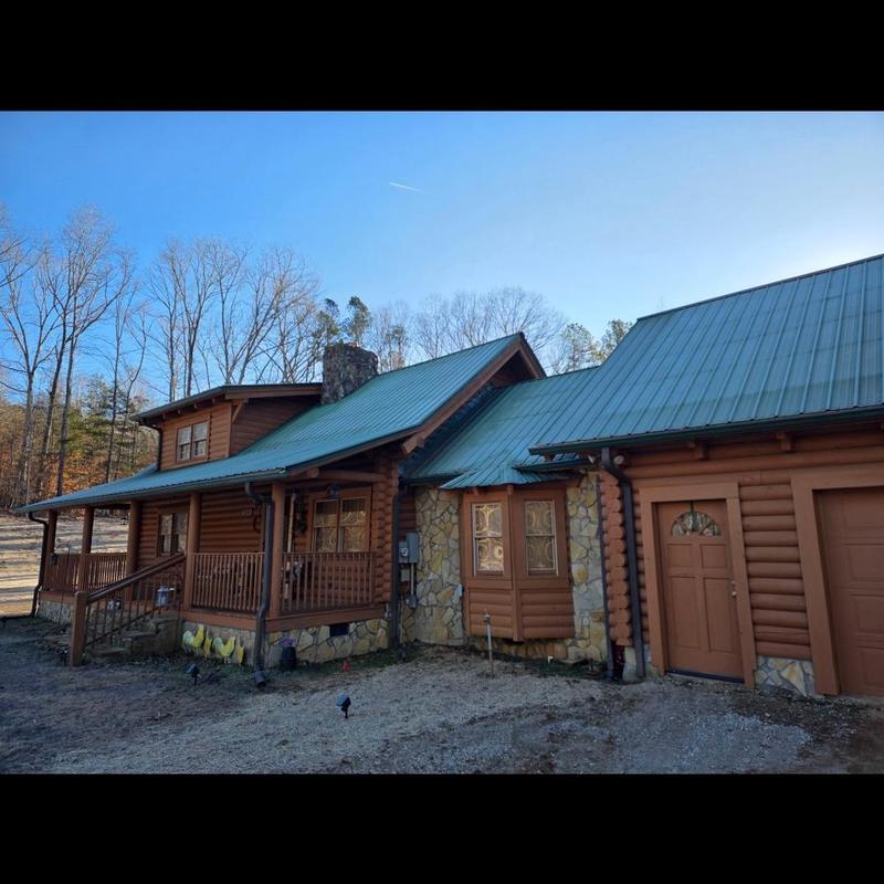 Metal roof installation on log cabin home