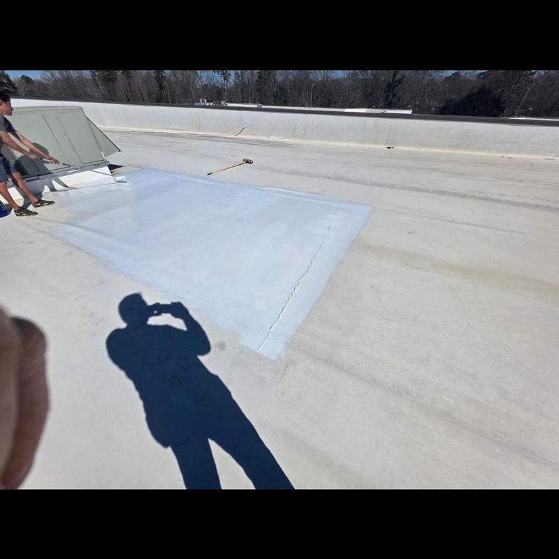 TPO roof silicone coating repair patch on flat roof