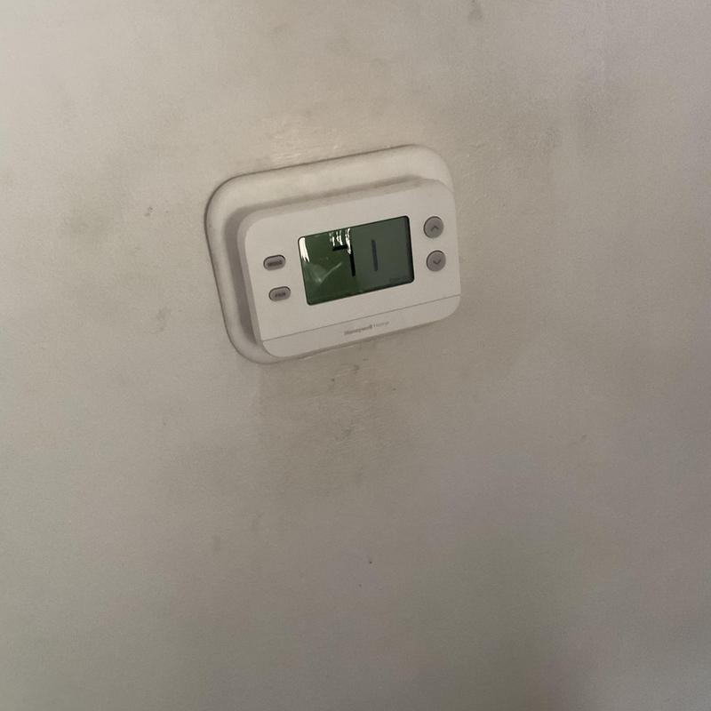 Thermostat wall unit displaying temperature setting Thermostat wall unit displaying temperature setting
