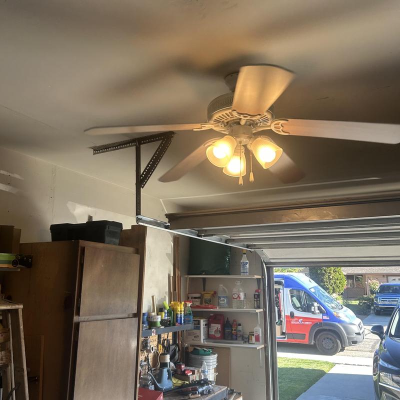 Ceiling fan with light fixture in garage powered on