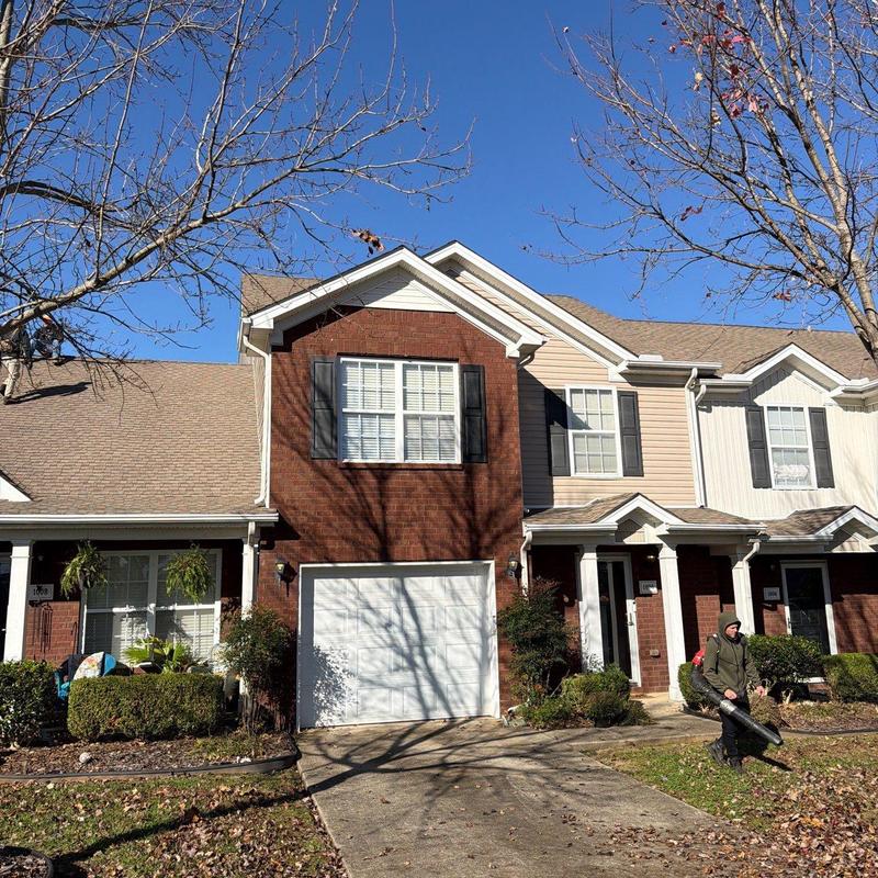 Shingle roof with hail damage on townhouse exterior