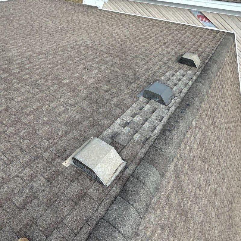 Roof shingles with vent caps and hail damage inspection
