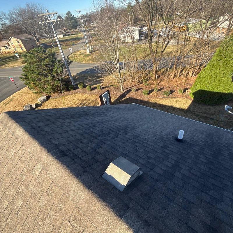 Roof shingles and ventilation vent inspection on condo roof