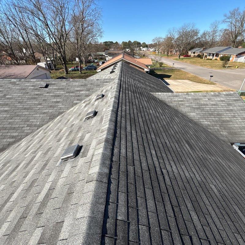 Asphalt shingle roof with ridge vents and hail damage