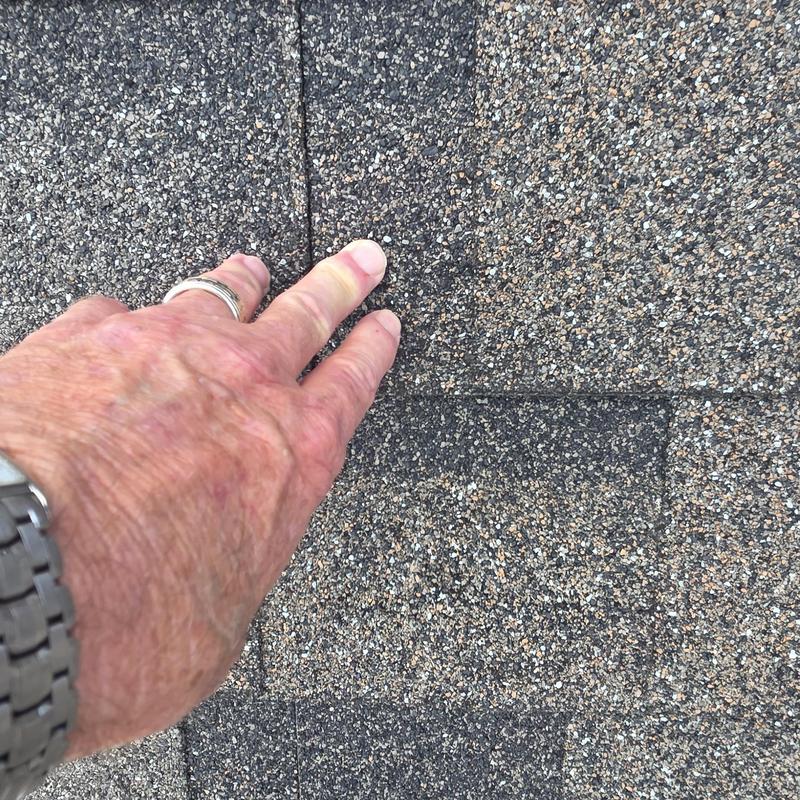 Roof shingles with hail impact damage close-up