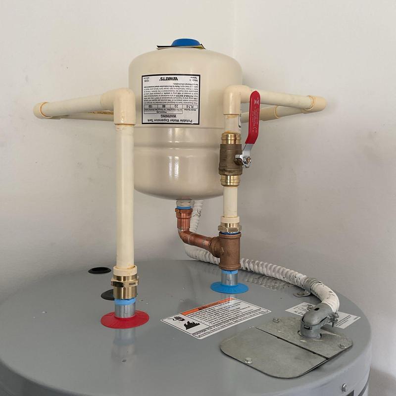 Water heater expansion tank with plumbing connections