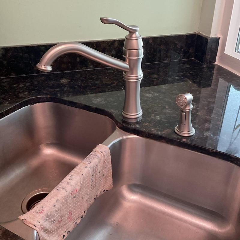 Kitchen faucet and spray nozzle on granite countertop