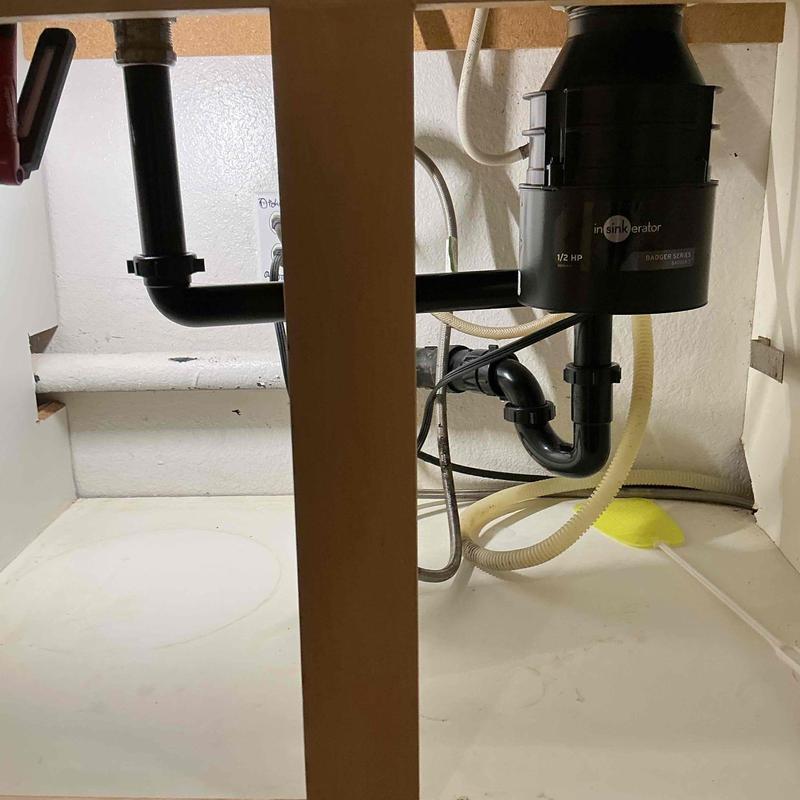 Garbage disposal with new tubular plumbing under sink