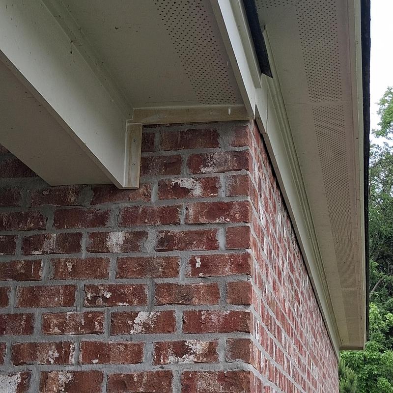 Hardie board trim and porch column wrapping near roof edge