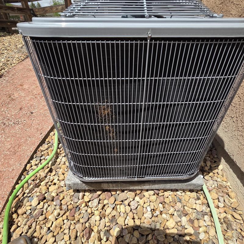 AC unit condenser coil with protective grille outdoors AC unit condenser coil with protective grille outdoors