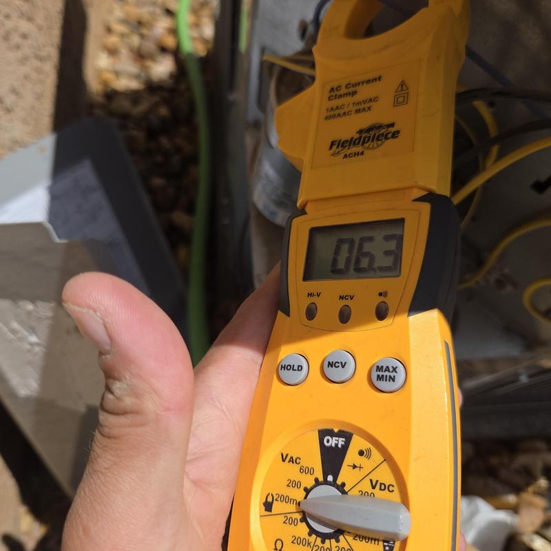 AC current clamp meter measuring voltage near unit AC current clamp meter measuring voltage near unit