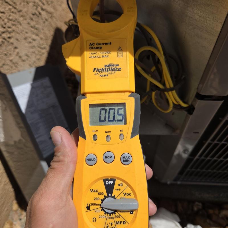 AC current clamp meter measuring voltage near unit AC current clamp meter measuring voltage near unit