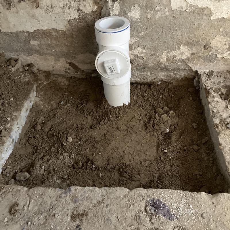 Sewer main cleanout pipe in excavated dirt pit Sewer main cleanout pipe in excavated dirt pit