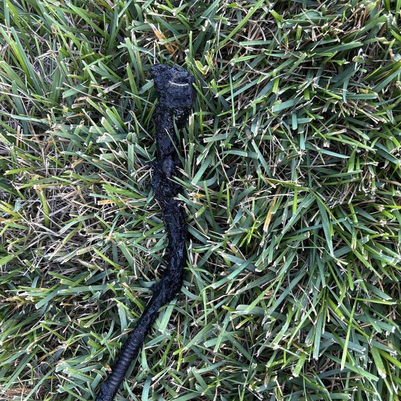 Sink drain cable with debris on grass