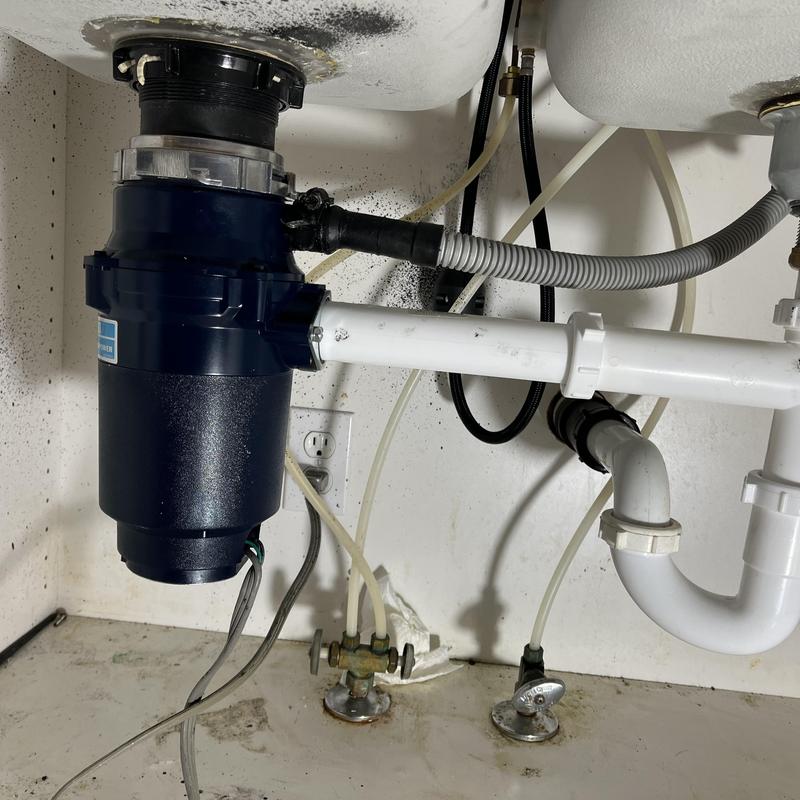 Garbage disposal and drain piping installation under sink Garbage disposal and drain piping installation under sink