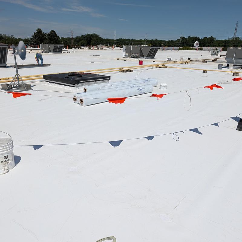 TPO roofing membrane installation with safety flags