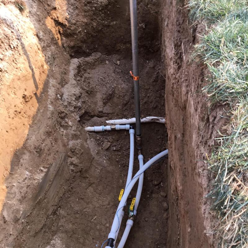 Underground water supply pipes with shutoff valves in trench Underground water supply pipes with shutoff valves in trench