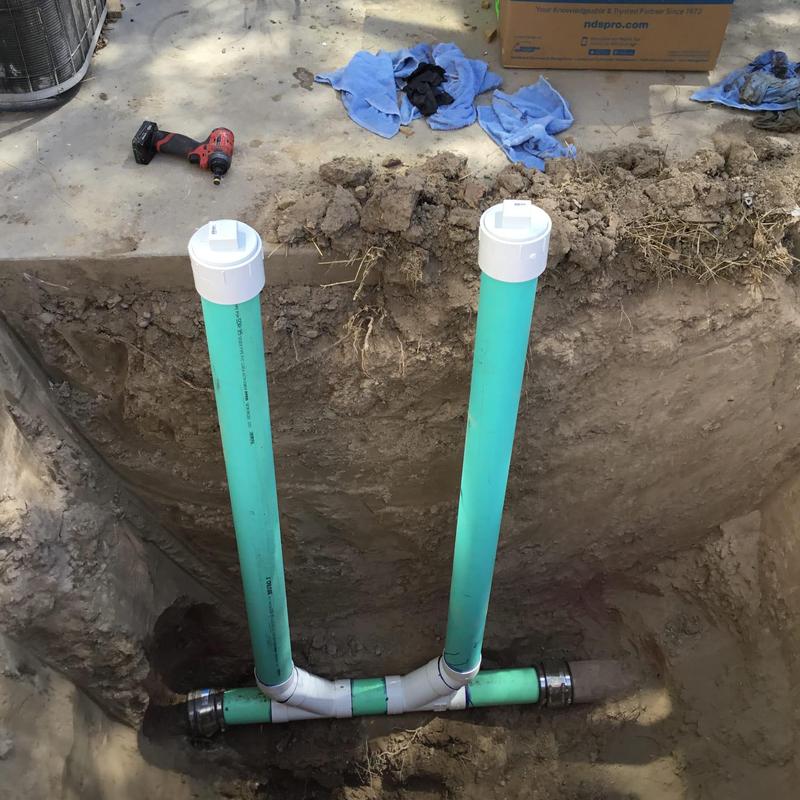 PVC sewer vent pipes installed in backyard excavation PVC sewer vent pipes installed in backyard excavation