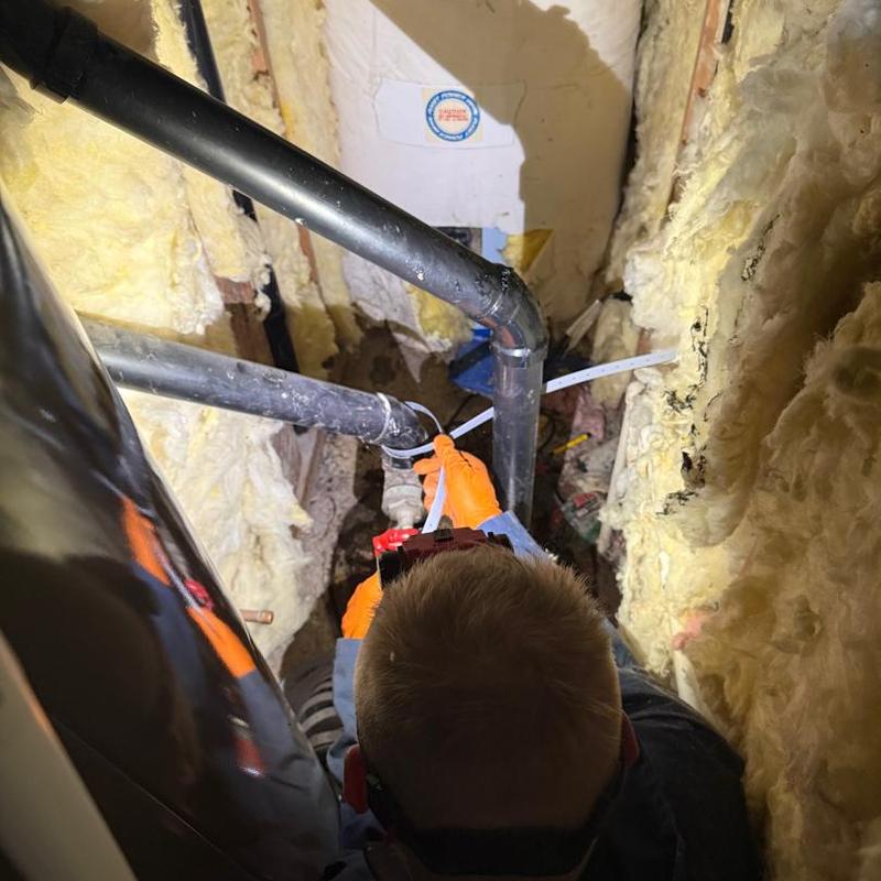 Sewage ejector pump installation with discharge pipe