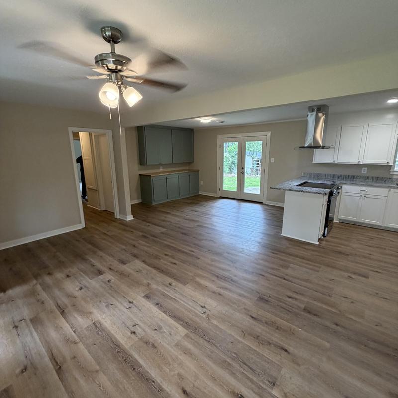 Vinyl plank flooring installation in open kitchen living area