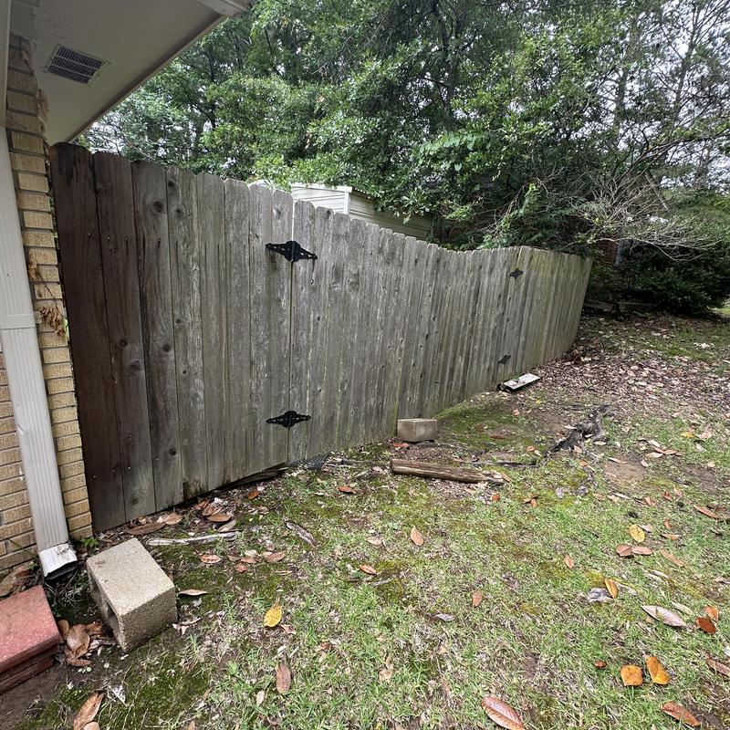 Wooden fence inspection with gate hinges in yard Wooden fence inspection with gate hinges in yard
