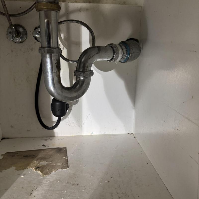 Galvanized drain pipe with new fittings under sink