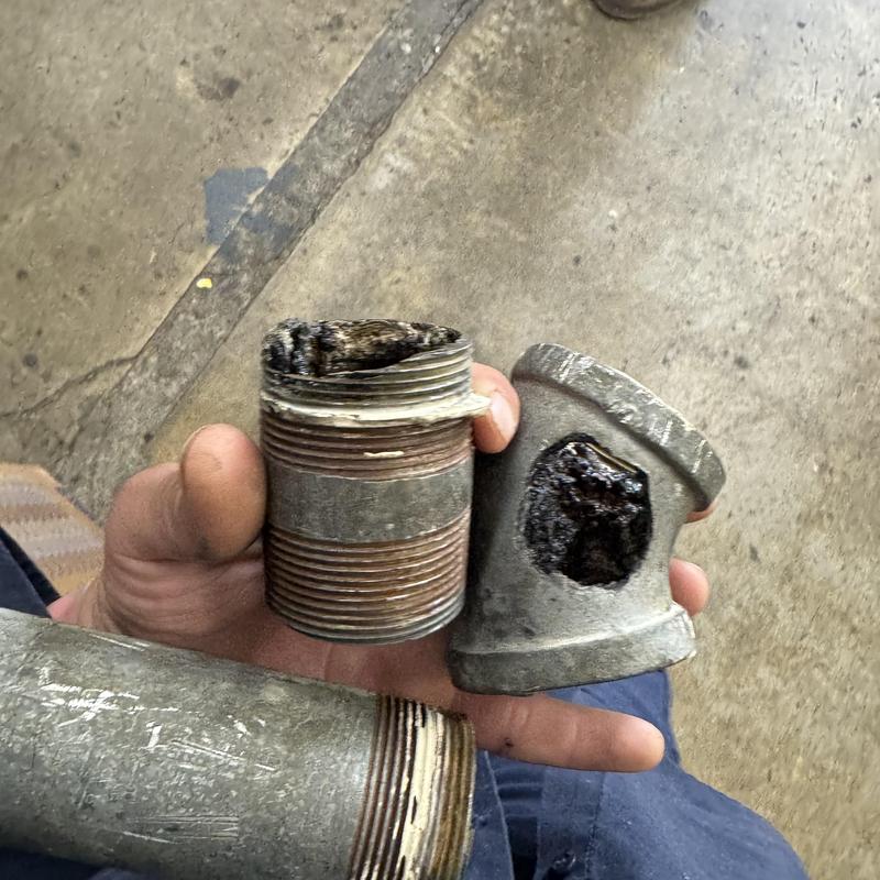 Galvanized drain pipe section with hole removed