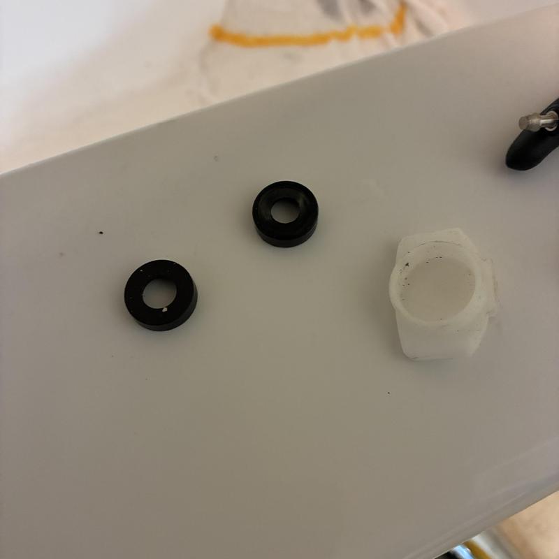 Tub spout gaskets and faucet mounting nut on countertop