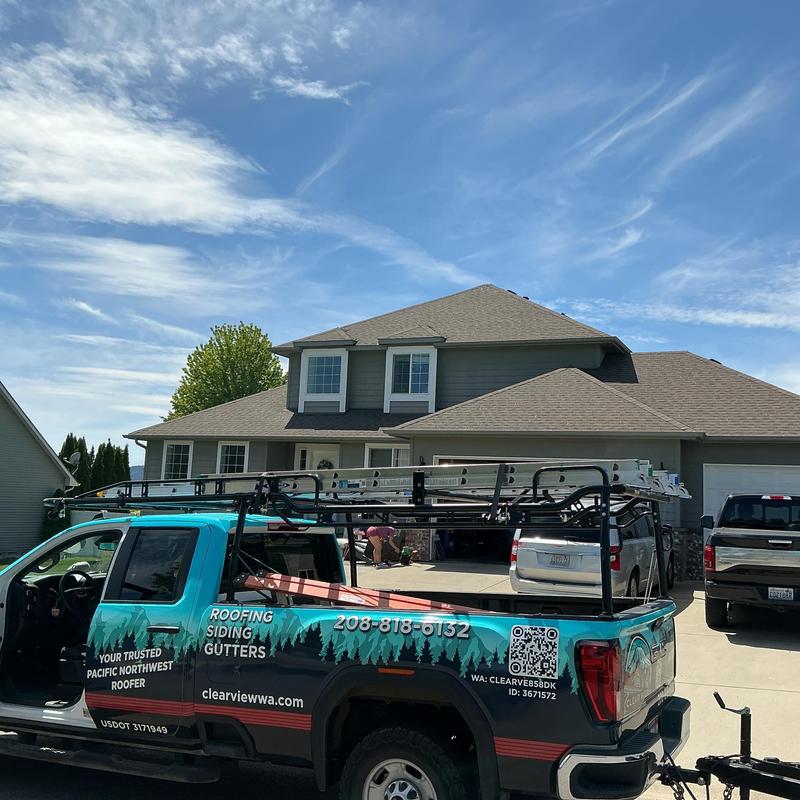 Roofing company truck with ladders parked at home Roofing company truck with ladders parked at home