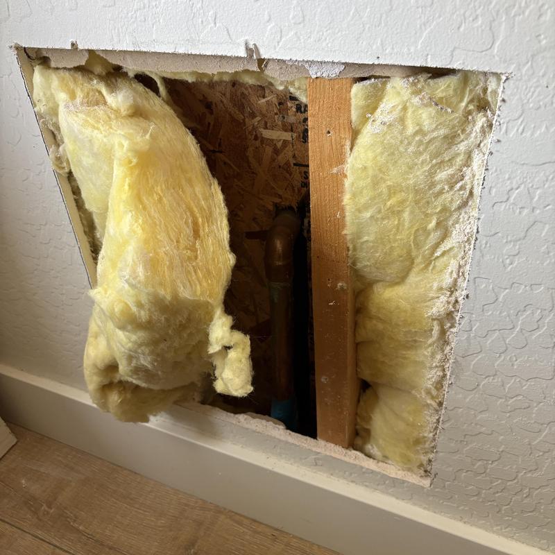 Copper plumbing pipe access behind drywall with insulation