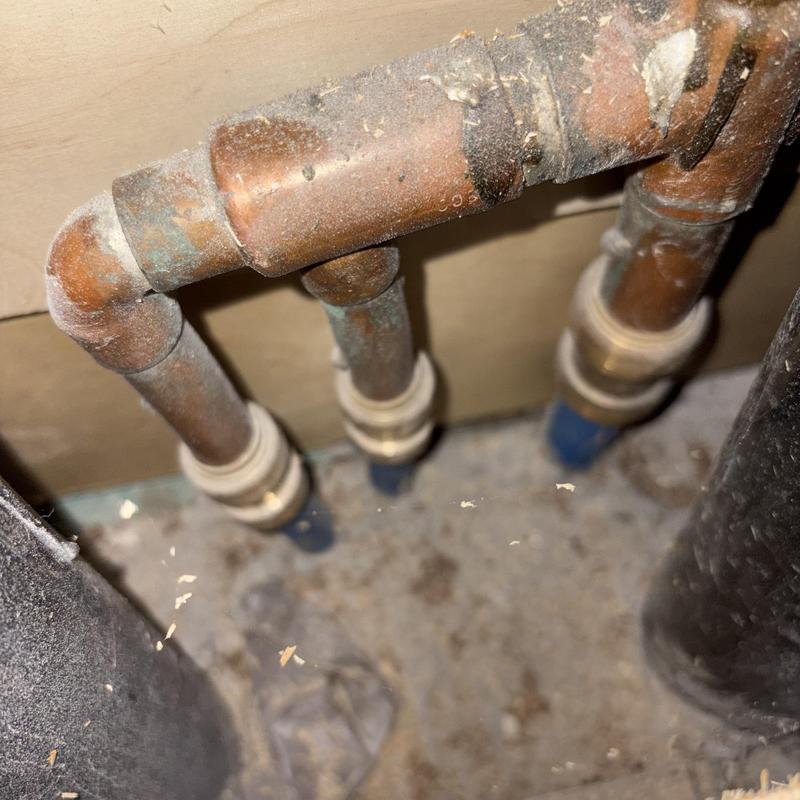 Copper water supply manifold pipes under kitchen sink