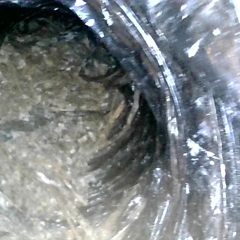 Exhaust duct with bird nesting contamination inside Exhaust duct with bird nesting contamination inside