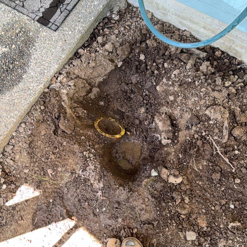 Outdoor sewer cleanout excavation for drain access in soil