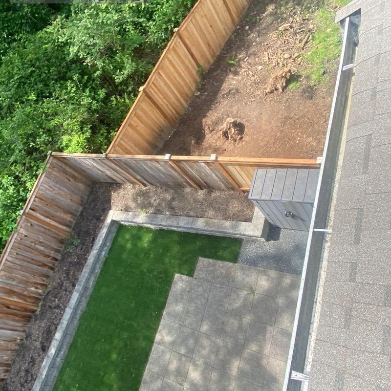 Gutter system cleaning with roof edge in backyard view