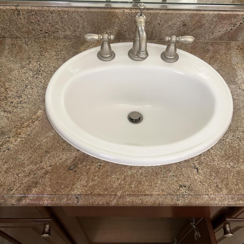Widespread bathroom faucet installed on granite countertop